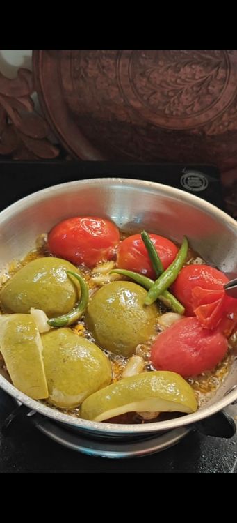 Step 1.1: Cook the raw mango and tomato on medium flame until the skin of the tomatoes starts to come out
