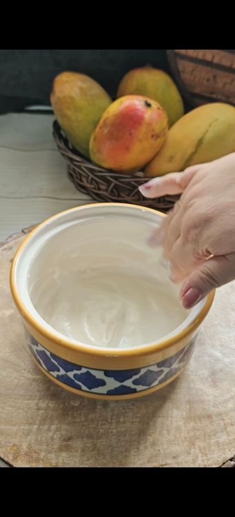 Step 1.1: Take an earthen pot and generously coat its sides from within with 1/4 cup of curd