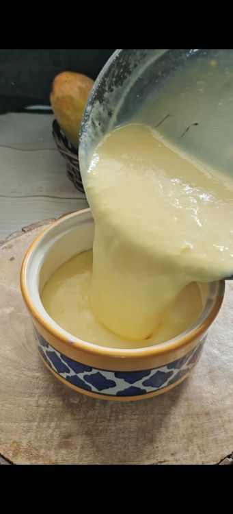 Step 1.1: Transfer the milk mixture to the earthen pot, cover it, and keep it at room temperature for 6-7 hours to allow the mango dahi to set