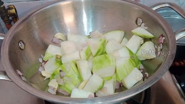 Step 1.2: Add blanched almonds and garlic pods, and toss for a few minutes
