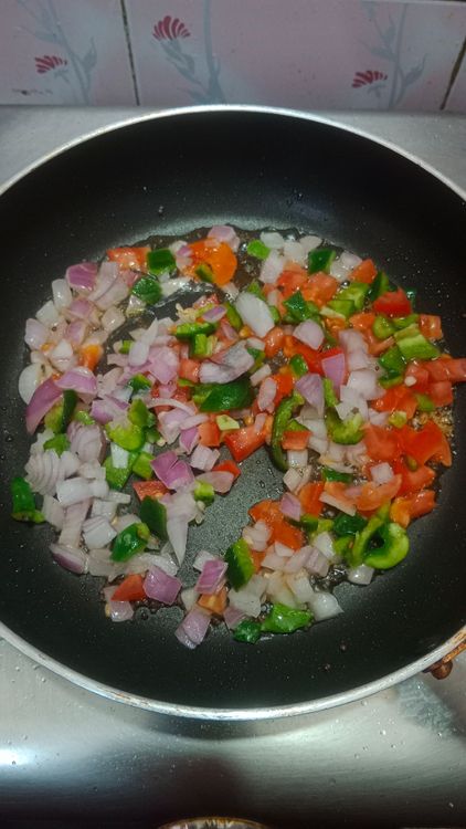 Step 1.1: Once the mustard seeds flutter, sauté the onion, tomato, and capsicum for 2 minutes