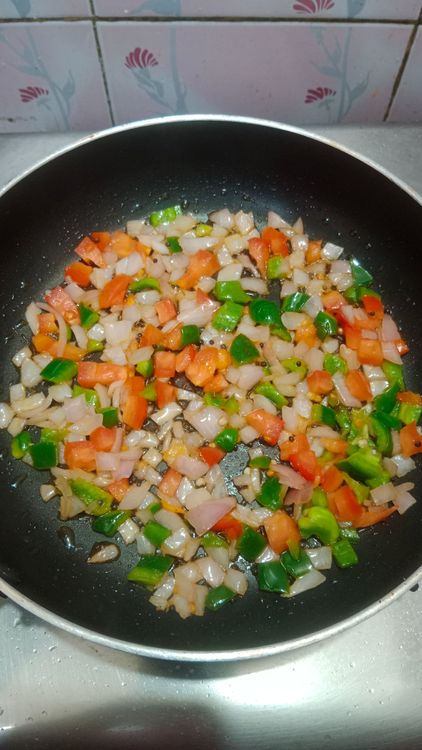 Step 1.2: Once the mustard seeds flutter, sauté the onion, tomato, and capsicum for 2 minutes