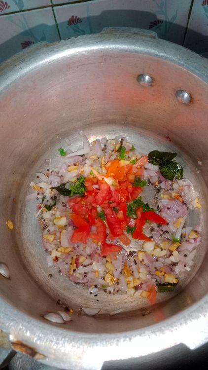 Step 2.1: Add the chopped tomato and some coriander leaves