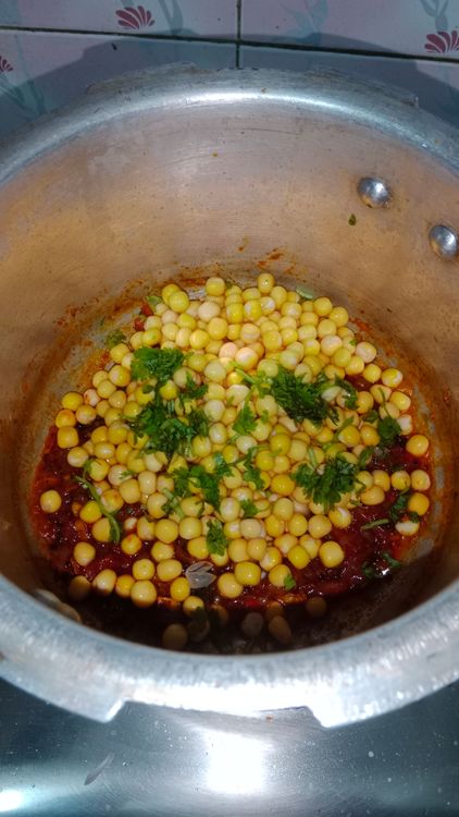 Step 2.1: Add the soaked white peas and some coriander leaves