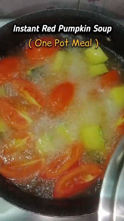 Step 1.2: Transfer the red pumpkin and tomatoes to a deep-bottom pan and add 3 cups of water