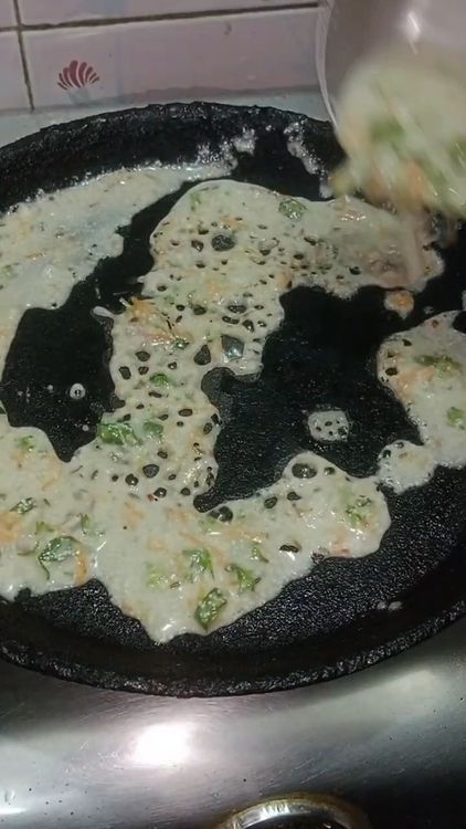 Step 2.1: Pour the batter evenly over the hot tawa