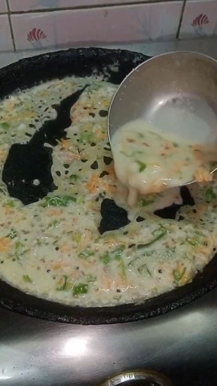 Step 2.2: Pour the batter evenly over the hot tawa