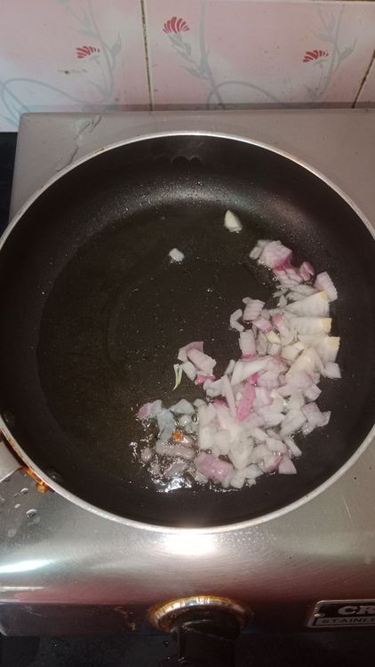 Step 2.1: Heat oil in a pan and sauté finely chopped onion until it turns translucent