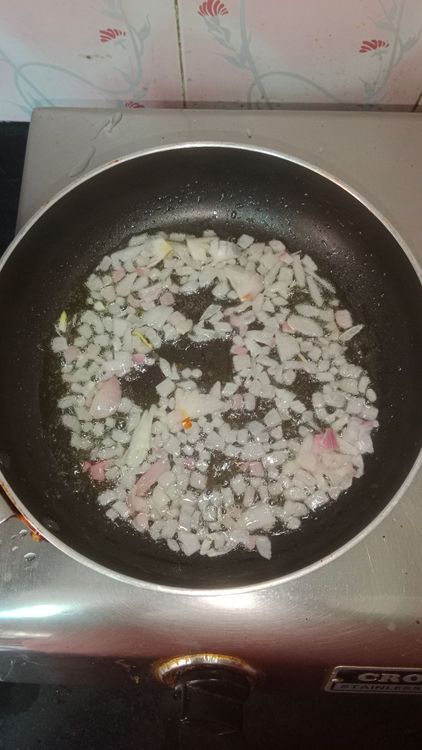 Step 2.2: Heat oil in a pan and sauté finely chopped onion until it turns translucent