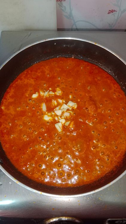 Step 2.1: Add crushed garlic pods with salt and cook the gravy until oil separates