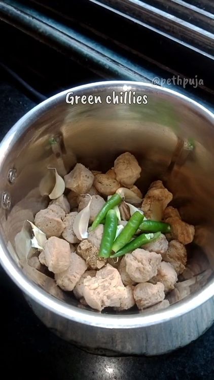 Step 1.1: In a mixie jar, add soaked soya chunks, garlic pods, green chillies, coriander leaves, and rolled oats