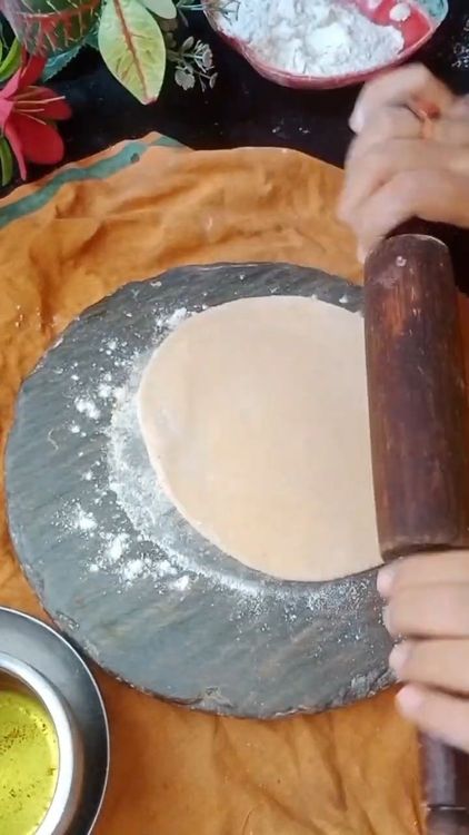 Step 2.1: Take a small ball of dough and roll it into a small roti