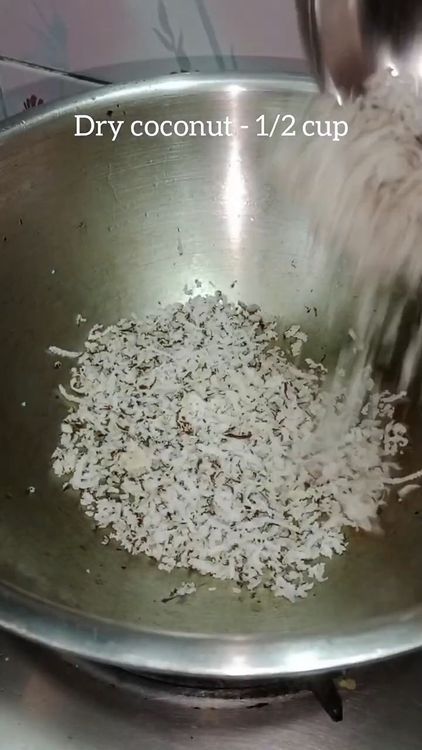 Step 1.1: Add shredded dry coconut to the pan and roast until it turns translucent