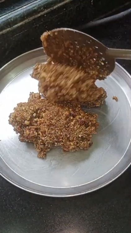 Step 5.1: Grease a plate with ghee and pour the mixture onto it