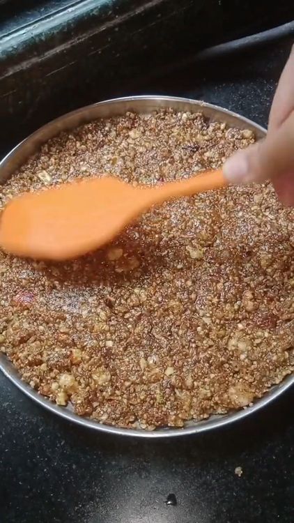 Step 5.2: Grease a plate with ghee and pour the mixture onto it