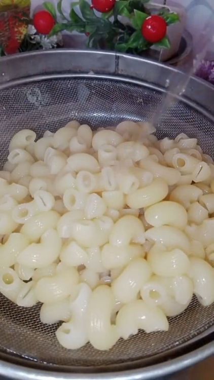 Step 1.2: Once the macaroni is cooked, strain it and rinse with cold water