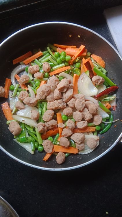 Step 3.1: Chop 1 onion, 1 small capsicum, a few strands of French beans, 1/4 cup green peas, and 1 small carrot