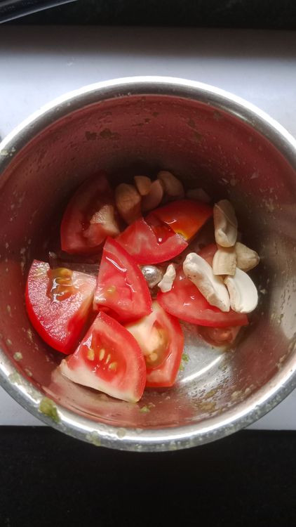 Step 2.1: Grind tomato and soaked cashews into a fine paste and add it to the cooked onion paste