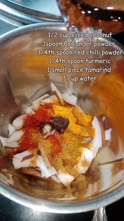 Step 2.1: In a mixie jar, add 1/2 cup coconut slices, 1 tbsp coriander powder, 3/4 tbsp red chilli powder, 1/4 tbsp turmeric, 1 small piece tamarind, and 1 cup water
