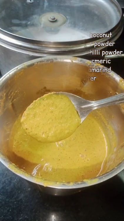 Step 2.2: In a mixie jar, add 1/2 cup coconut slices, 1 tbsp coriander powder, 3/4 tbsp red chilli powder, 1/4 tbsp turmeric, 1 small piece tamarind, and 1 cup water