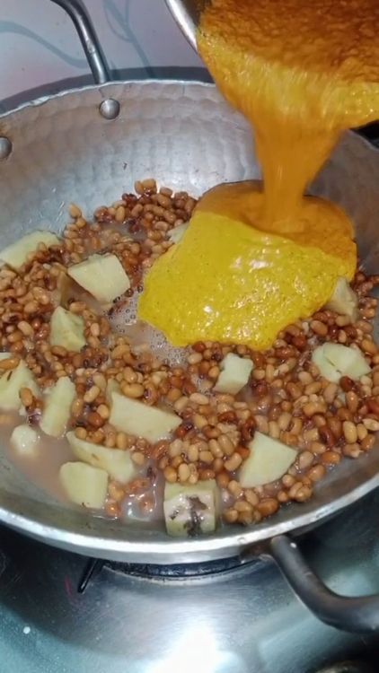 Step 3.1: Add the coconut paste to the boiling mixture of yam and red moong