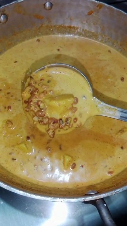 Step 3.2: Add the coconut paste to the boiling mixture of yam and red moong