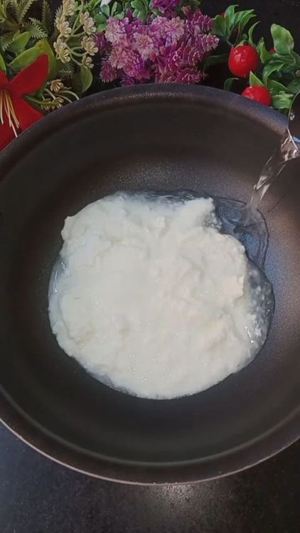 Step 1.2: In a bowl, add 4 cups of homemade thick curd and 2 cups of water