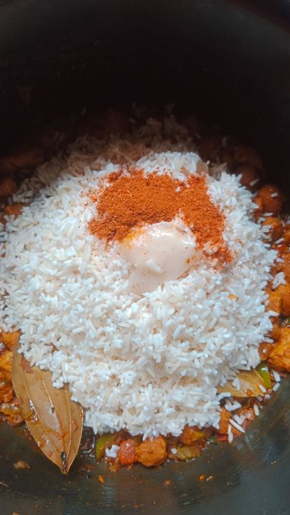 Step 2.1: Add the washed rice, garam masala, ghee, and hot water