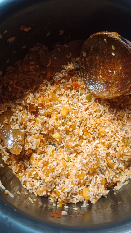 Step 2.2: Add the washed rice, garam masala, ghee, and hot water