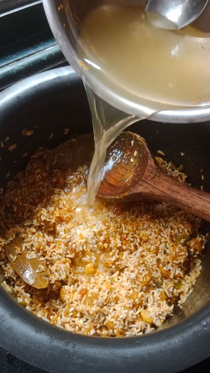 Step 2.3: Add the washed rice, garam masala, ghee, and hot water
