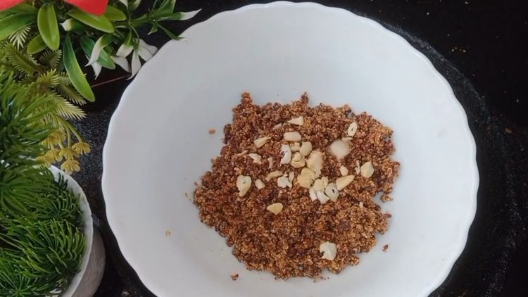 Step 1.2: In a mixing bowl, combine roasted peanut powder, jaggery powder, ghee, roasted cashews, and cardamom powder and senda namak