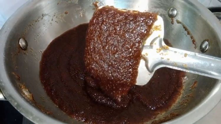 Step 1.2: Pour the jaggery syrup into the suji mixture and add green cardamom powder