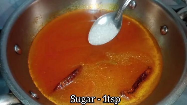Step 3.1: Pour in 4 cups of water, add a pinch of sugar, curry leaves, and bhaja masala