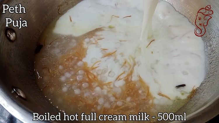 Step 1.1: Pour in the full cream milk and add the crushed green cardamom