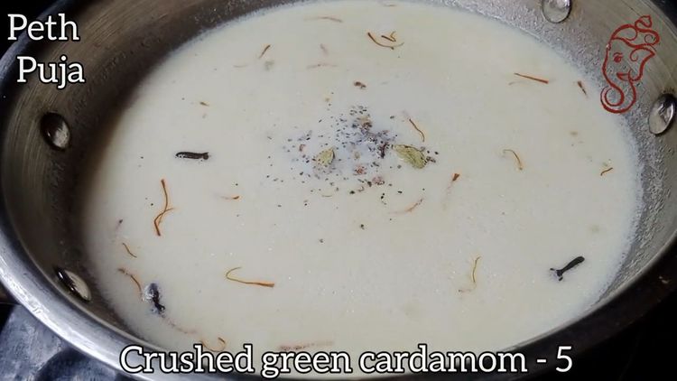 Step 1.2: Pour in the full cream milk and add the crushed green cardamom