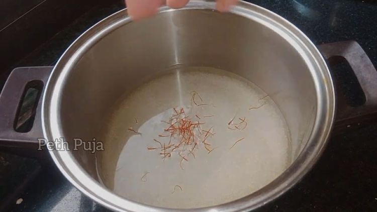 Step 2.1: In a pan, boil sugar and water on medium to low flame till slightly sticky (1- string consistency)