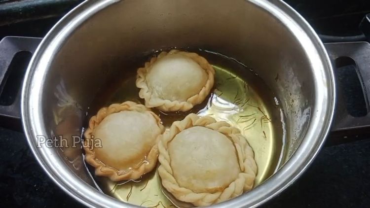 Step 5.1: Dip the fried Chandrakalas in the sugar syrup, ensuring they are well-coated and remove
