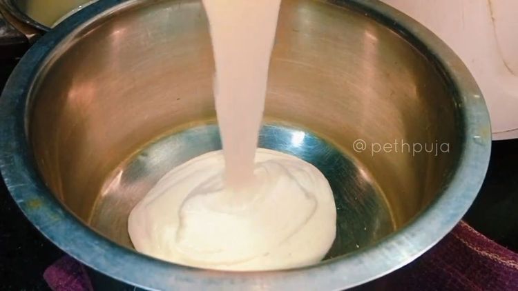 Step 1.2: Grind the soaked ingredients into a fine paste of thick consistency, adding flattened poha during grinding