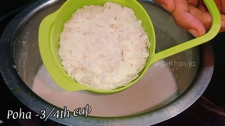 Step 1.1: Grind the soaked ingredients into a fine paste of thick consistency, adding flattened poha during grinding
