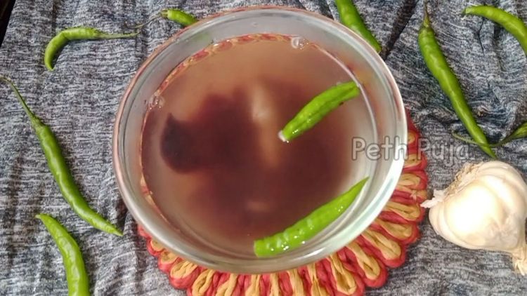 Step 1.2: Soak mangosteen (kokam) pieces, crushed garlic, green chillies, and asafoetida in warm water for 15-20 minutes