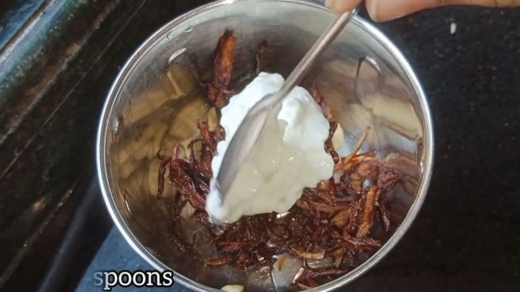 Step 2.2: Deep fry sliced onions and make a fine paste by blending them with curd and cashew nuts