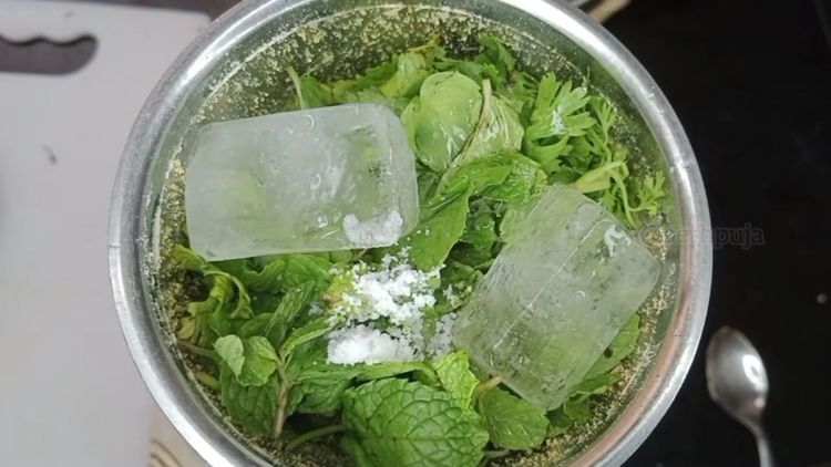 Step 1.1: Add fresh coriander leaves, mint leaves, ice cubes, and salt to the grinder
