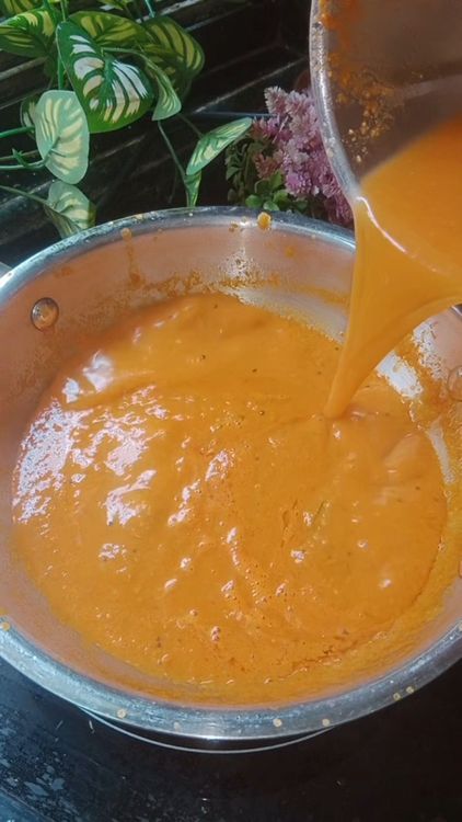 Step 1.1: Add the boiled tomato water to the mixie jar, mix well, and pour it into the pan