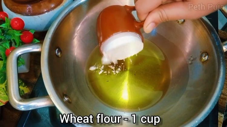 Step 1.1: Add whole wheat flour to the melted ghee and roast it, stirring continuously, until it turns golden brown and releases a nutty aroma