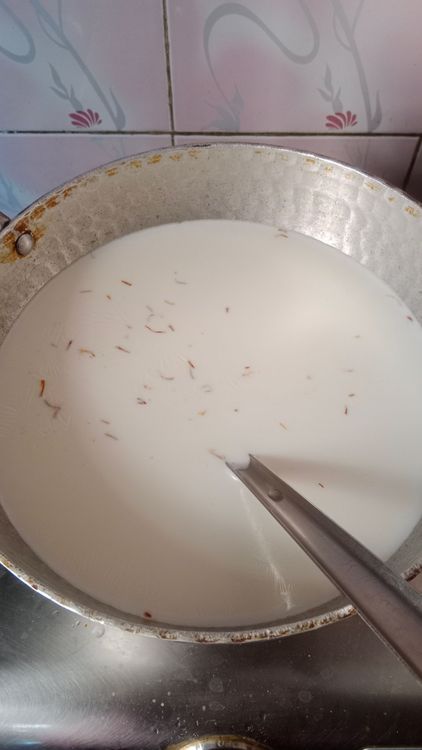 Step 1.1: Add sugar, cardamom powder, saffron (if using), chironji, and chopped nuts to the milk