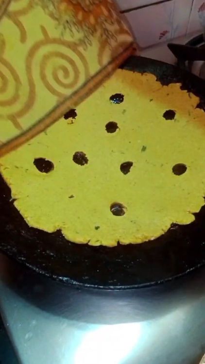 Step 1.1: Make holes in the dough and fry both sides well on a tawa until cooked