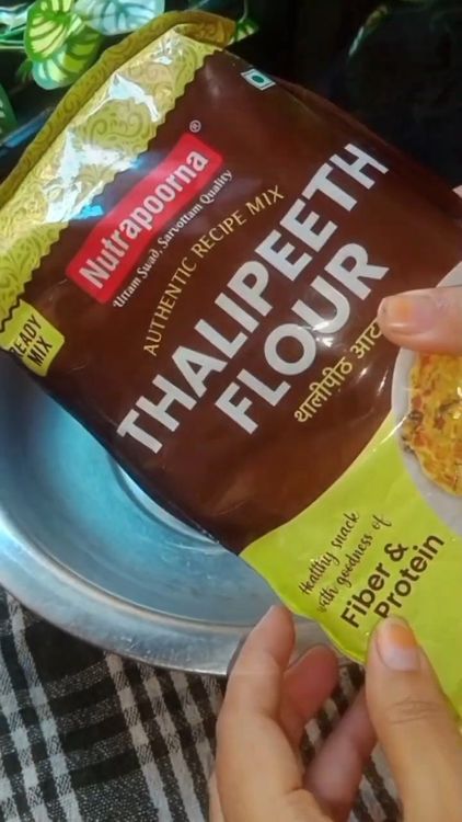 Step 1.1: In a bowl, mix thalipeeth flour, turmeric powder, peanut powder, red chilli powder, carrom seeds, kasoori methi, asafoetida, and salt using your fingers