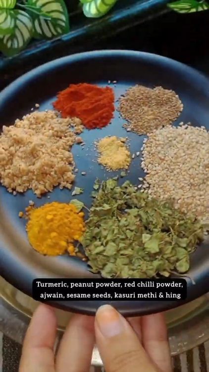 Step 1.2: In a bowl, mix thalipeeth flour, turmeric powder, peanut powder, red chilli powder, carrom seeds, kasoori methi, asafoetida, and salt using your fingers