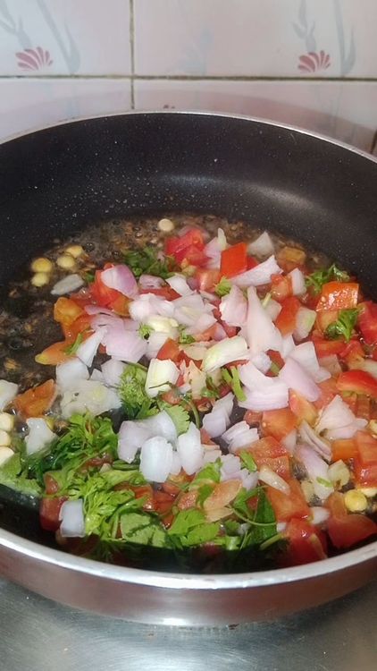Step 1.1: Add finely chopped onion, tomatoes, garlic, green chilli, coriander leaves, and curry leaves