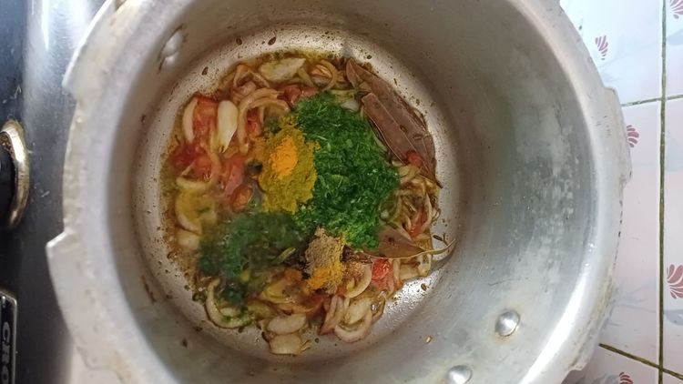 Step 2.1: Add the green paste along with salt, turmeric, and coriander powder